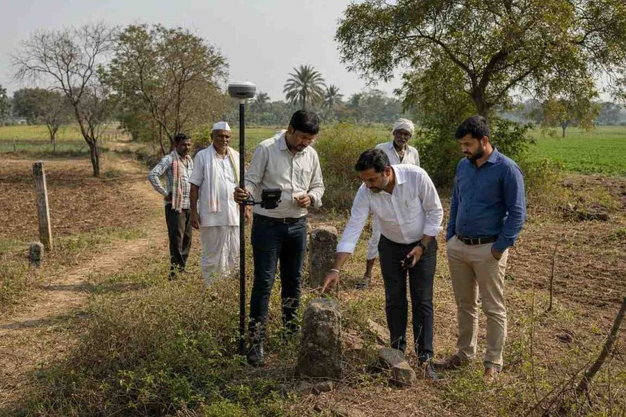 villagers-verifying-old-boundary-stone-marker