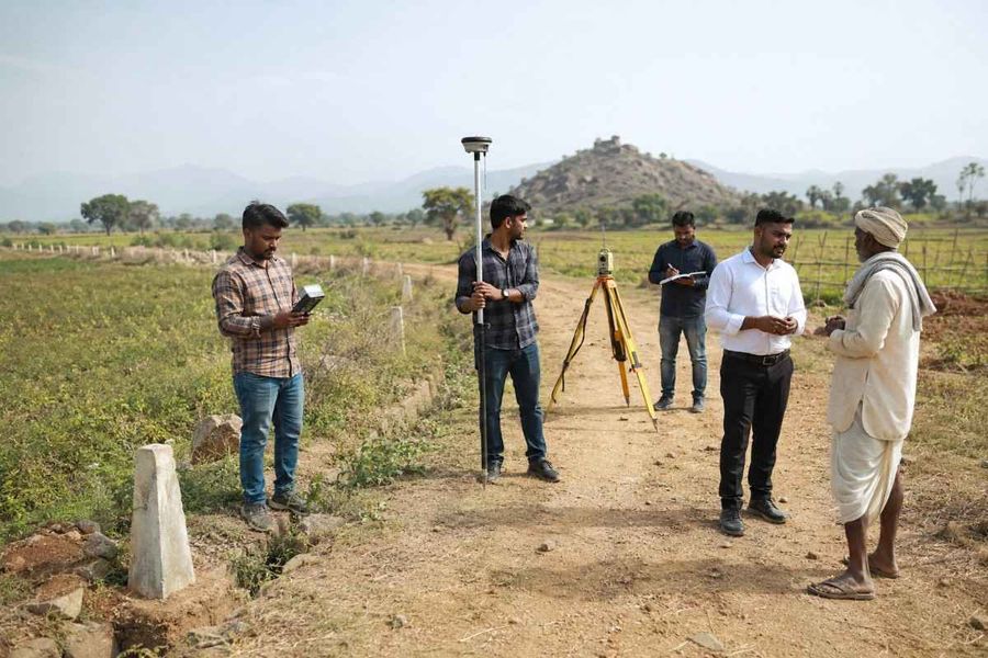 gps-survey-team-farmer-boundary-discussion.jpg